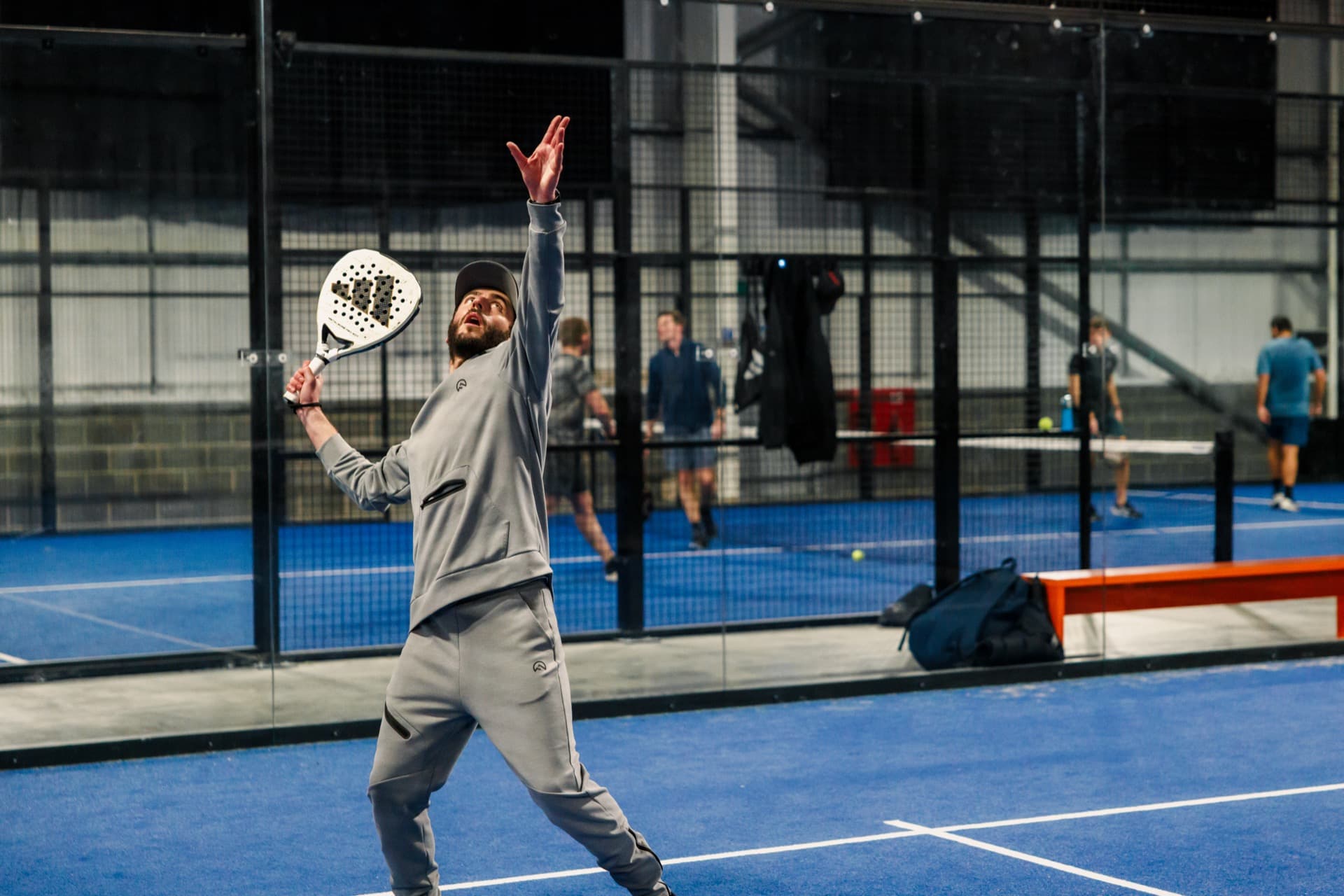 Absolute Padel player serving